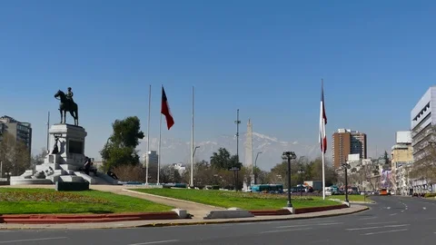 Two Chilean cops pass by a close up view of Plaza Baquedano Stock Footage 97471029