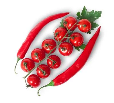 Two chili pepper and cherry tomatoes on stem with parsley Stock Photos