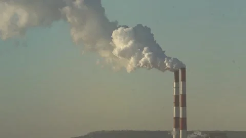 The two chimneys of the power plant give off white puffs of smoke Polluting Stock Footage 284222969