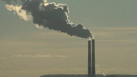The two chimneys of the power plant give off white puffs of smoke Polluting Stock Footage 284223162