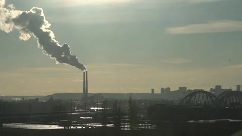 The two chimneys of the power plant give off white puffs of smoke Polluting Stock Footage 284223265