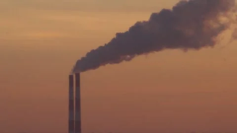 The two chimneys of the power plant give off white puffs of smoke Polluting Stock Footage 284223536