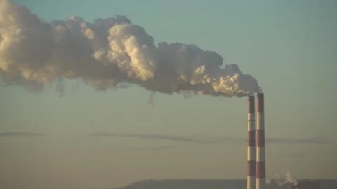 The two chimneys of the power plant give off white puffs of smoke Polluting Stock Footage 284223687