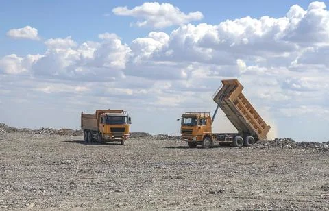 Two Chinese mining dump trucks are loading ore Stock Photos