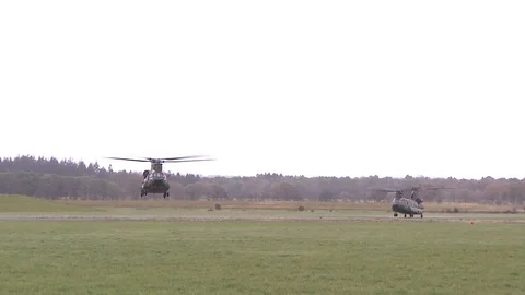 Two Chinook helicopters take off, US military Stock Footage 120948375