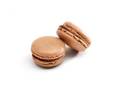 Two chocolate macaroons on white surface. Stock Photos