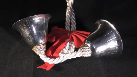 Two christmas bells on black surface and rotating Video stock 111273932