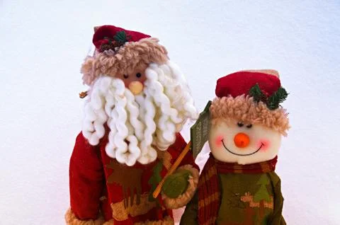 Two Christmas toys on a snow background Stock Photos