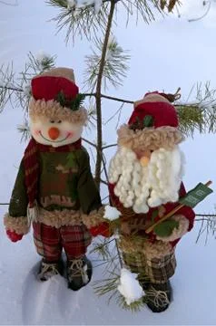 Two Christmas toys on a snow background Stock Photos