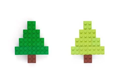 Two christmas trees made of plastic bricks on a white background Foto stock