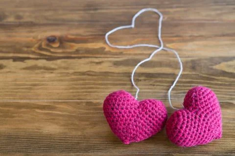 Two chrocheted hearts with threads Stock-Fotos