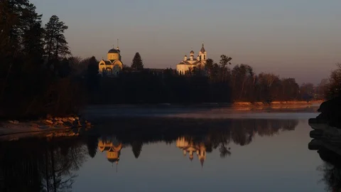 Two Church domes at sunset by the river with a reflection in the water. Stock Footage 128332202