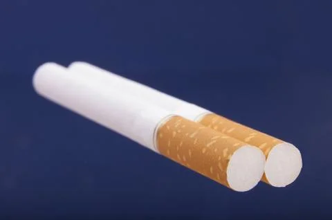 Two cigarettes on blue background Foto stock