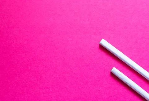 Two cigarettes flat on a pink background. Concept of female smoking, smoking  Stock Photos