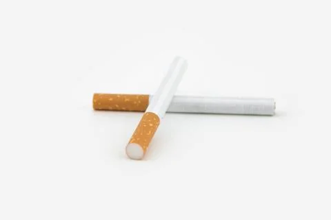 Two cigars isolated on white background. Filtered cigarettes. Stock Photos