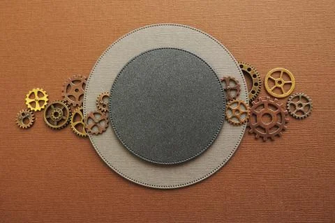Two circles of different sizes on a brown background and metal gears. Space f Foto stock