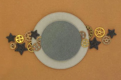 Two circles of different sizes on a brown background, metal gears and black s Stock Photos