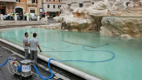 Two city workers talk and clean coins from Trevi Fountain - Wide, Handheld, 4K Stock Footage 156240304