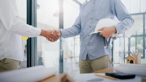 Two civil engineer or architect handshaking have deal mega project. Stock Photos