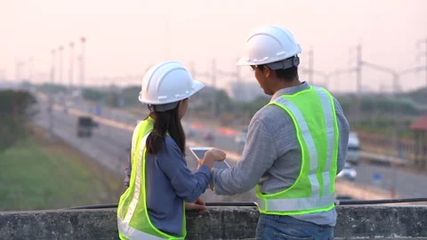 Two civil Engineering working with tablet on bridge highway Stock Footage 147398965
