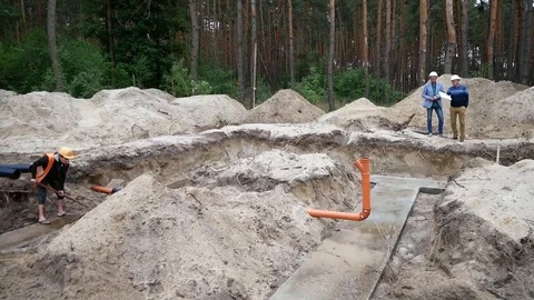 Two civil engineers are discussing the construction project Stock Footage 77679209
