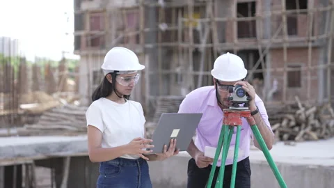 Two civil engineers doing a survey on a construction site. Video stock 161808498