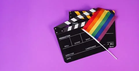 Two Clapper board and rainbow pride flag on purple or violet background. 写真素材