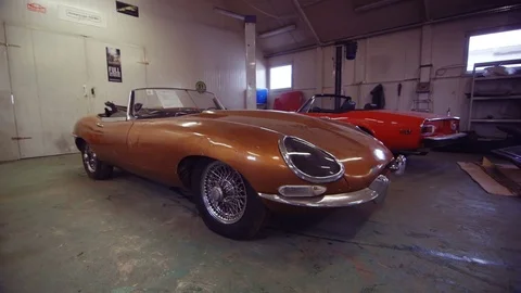 Two Classic Cars in a Workshop. Lean-Out. Cars Ready to Restore Stock Footage 77925937