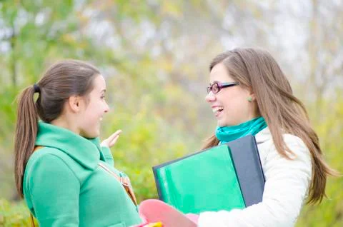 Two classmates talking in the forest Stock Photos