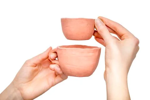 Two clay cups in  woman's hands Stock Photos