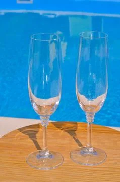 Two clean glasses on background of pool Stock Photos