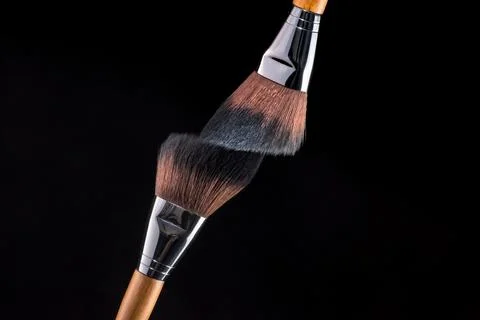 Two clean make-up cosmetic brushes on black background. Stock Photos