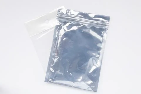 Two clear gray plastic bags with a zip closure on a white background, empty.. Stock Photos