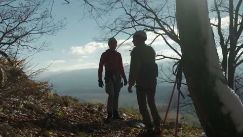 Two climbers are talking to each other on the background of the mountains Stock Footage 171945609