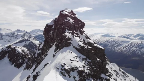 Two climbers ascending a steep mountain in Norway aerial rear view Stock Footage 99738383