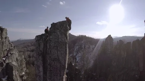 Two Climbers on a Cliff Top. Sunny Winter Day Backlight Video stock 71386731