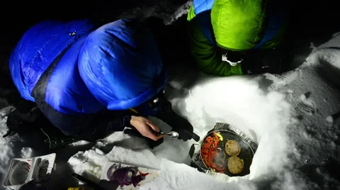 Two Climbers Cook Outdoors in Winter Stock Footage 60653556