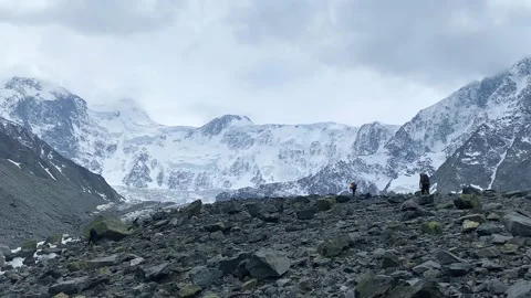 Two climbers with large backpacks are walking on the rocks Video stock 246060936