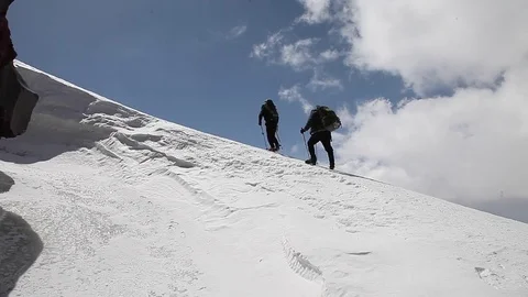 Two climbers on a sky background Stock Footage 83729203