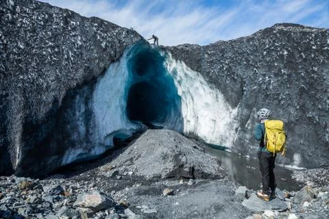 Two climbing guides exploring a huge ice cave on the Matanuska Glacier in Ala Stock Photos