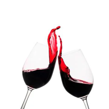 Two clinking glasses of red wine in a toast Stock Photos