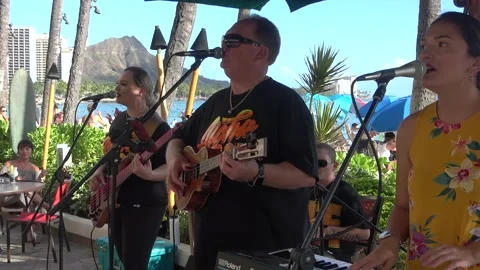 Two Clips Of Beach Band Plays Hawaiian Music, Duke's Waikiki, Honolulu, Hawaii Stock Footage 154342122