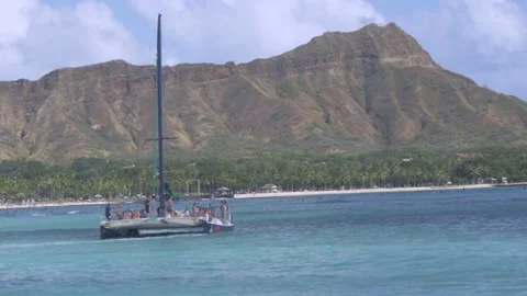 Two Clips Of Crowded Catamaran Boat On Waikiki Beach, Honolulu, Hawaii Stock Footage 154344929