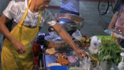 Two Clips Of Man Making Street Tacos In Mexico City Stock Footage 154645356
