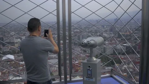 Two Clips Of Man Taking Photo From Top Of Torre Latinoamericana, Mexico City Stock Footage 154671398