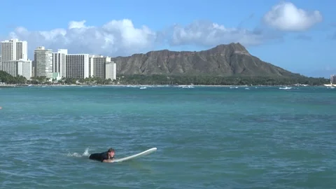 Two Clips Of Overweight Tourist Trying To Surf, Waikiki Beach, Honolulu, Hawaii Stock Footage 154345599