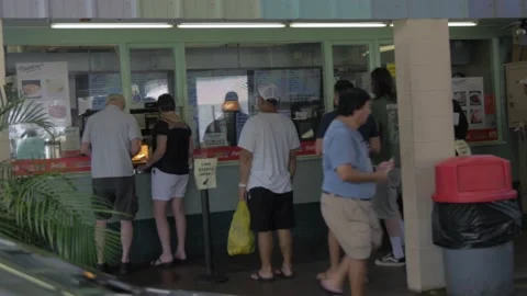 Two Clips Of People Waiting In Line At Rainbow Drive-In In Honolulu, Hawaii Stock Footage 154294415