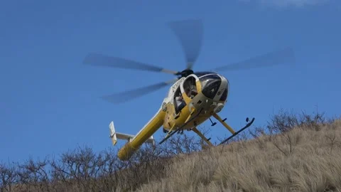 Two Clips Of Rescue Helicopter Flying Away At Diamond Head In Honolulu, Hawaii Stock Footage 154181876