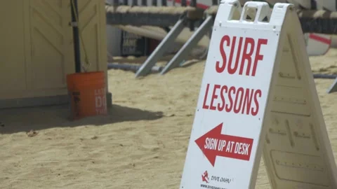 Two Clips Of Surf Lessons Sign And Tent On Waikiki Beach, Honolulu, Hawaii Stock Footage 154342577