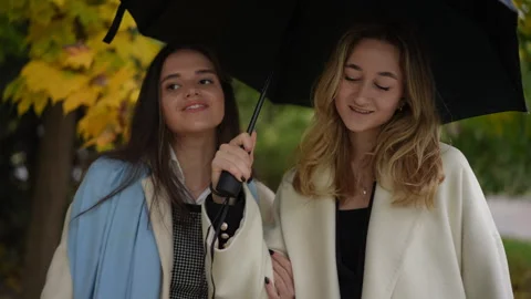 Two close friends are joyfully enjoying a beautiful autumn day together Stock Footage 297392927